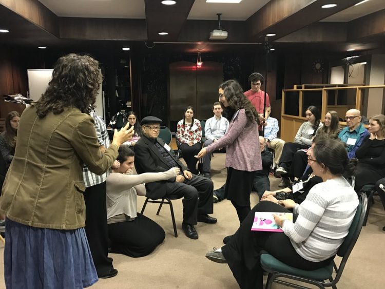students and holocaust survivors performing a play